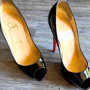 Black Christian Louboutin open toe heels.